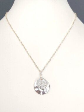 Silver tone hammered pendant necklace with pave cz disk overlay